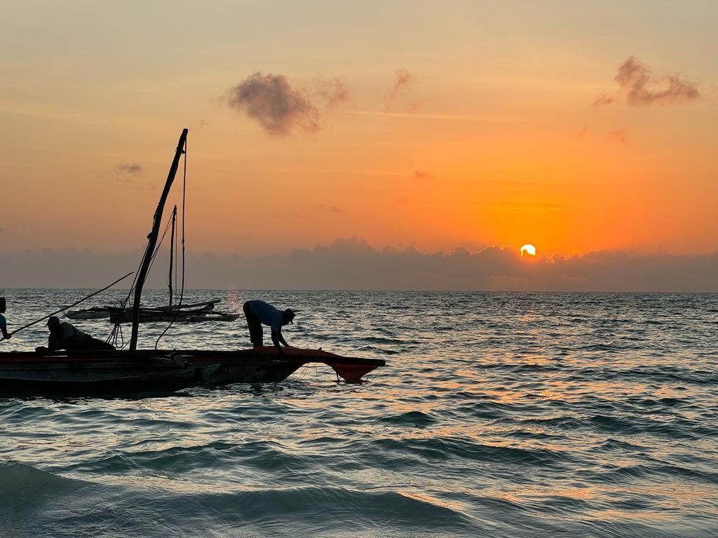 A dhow silhouetted against the sunrise