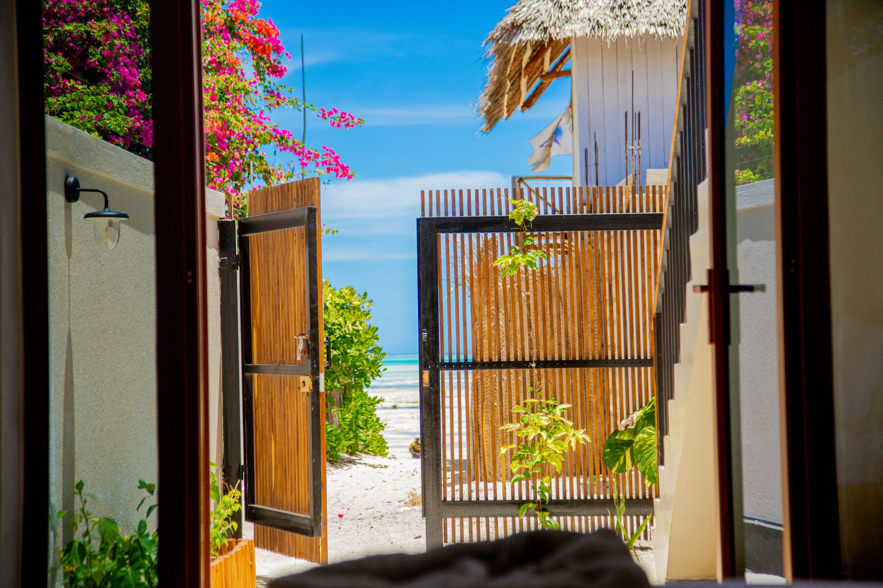 Wooden doors opening straight onto the beach